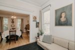 The West Side Living Room Flows Into Peach Mansions Spacious Dining Area, Offering a Warm and Inviting Space for Both Relaxation and Dining